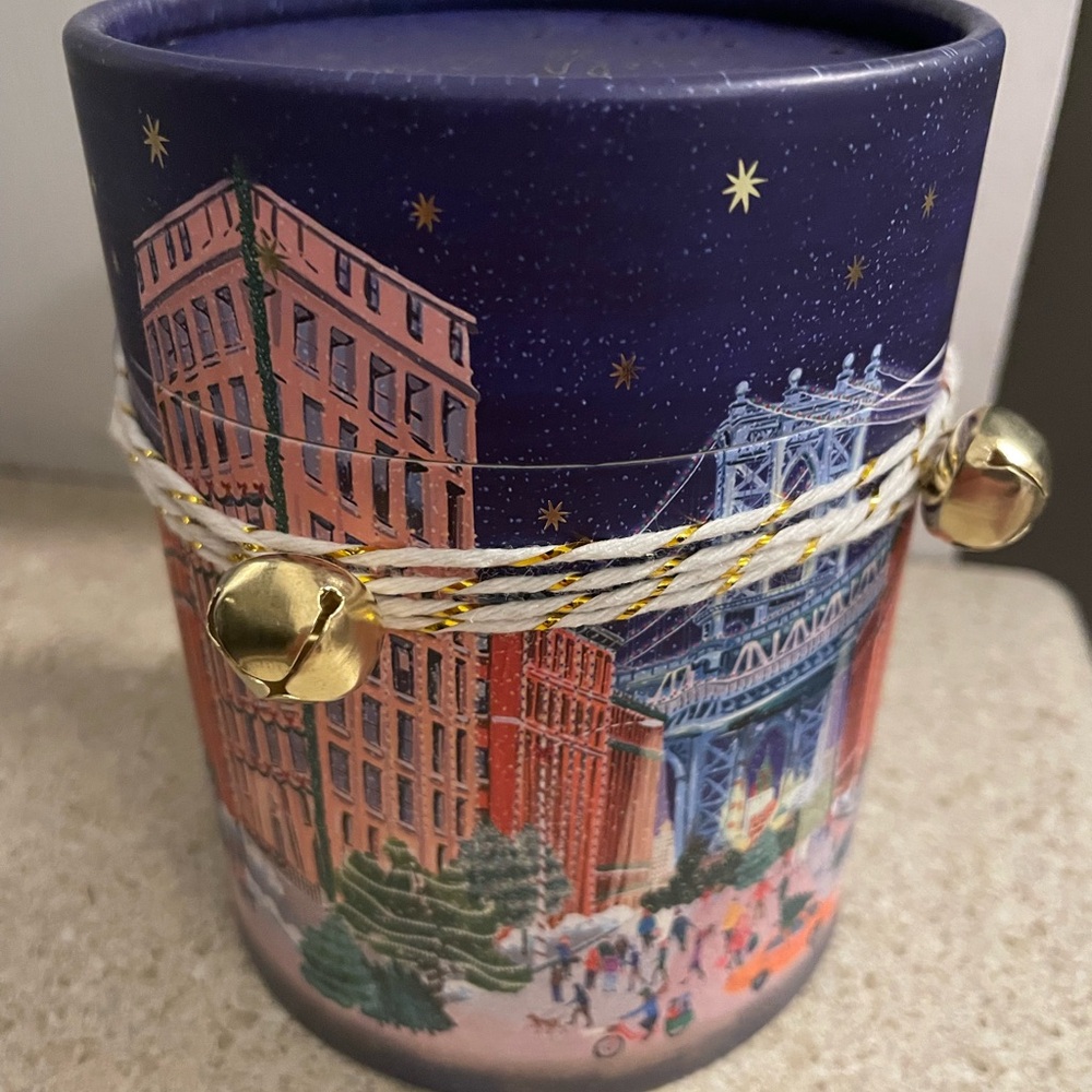 Festive NYC Cityscape Candle with Gold Bells